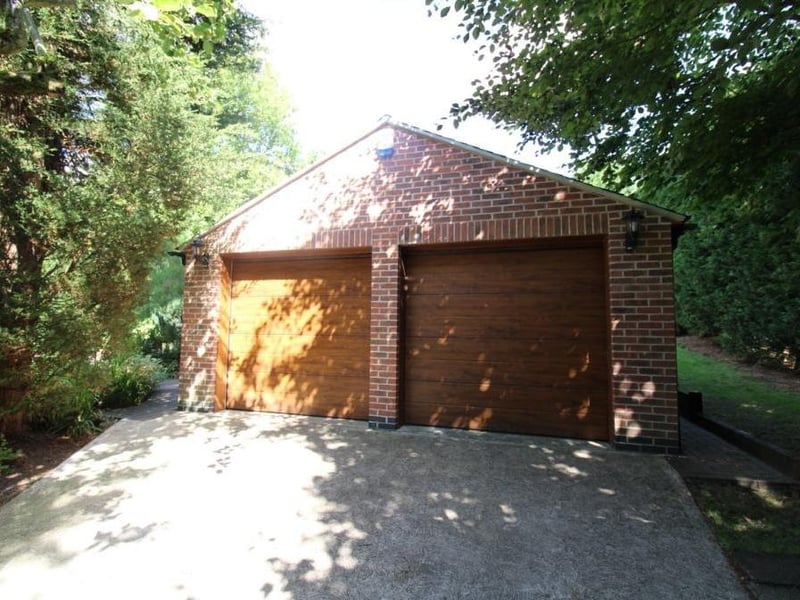 One of the driveways leads to this detached double garage, with two electric roll-up doors, light and power. Other outbuildings in the grounds include a brick-built potting shed, brick-built coal house, log store and greenhouse.