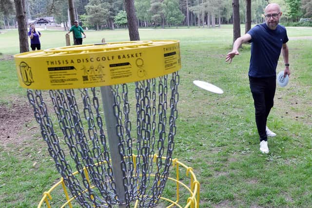 Chad editor Ashley Booker playing disc golf at Sherwood Pines.