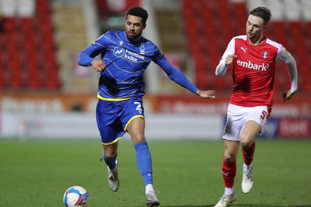 Nottingham Forest's Cyrus Christie is challenged by Lewis Wing of Rotherham United.