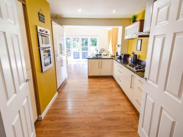 Carry on down the hallway and you come to this open-plan kitchen, which extends into a diner and, ultimately, to bi-folding doors that emit swathes of natural light and lead to the garden..