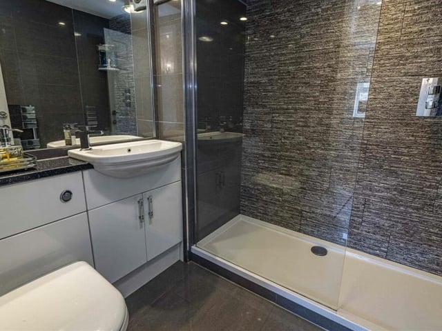 The en suite shower room to the master bedroom is a sparking space, featuring a double shower enclosure, hand wash basin, low-flush WC and modern fixtures, fittings and tiling.