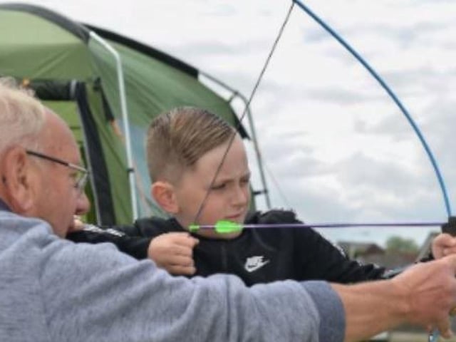 Tony Rich of Greasley Castle Archery, shows Keegan Garriock how to do it at the 2019 Greasley Gathering.