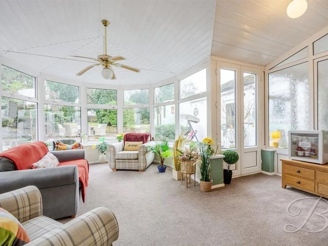 A bright conservatory opens directly onto the garden, blending indoor and outdoor living