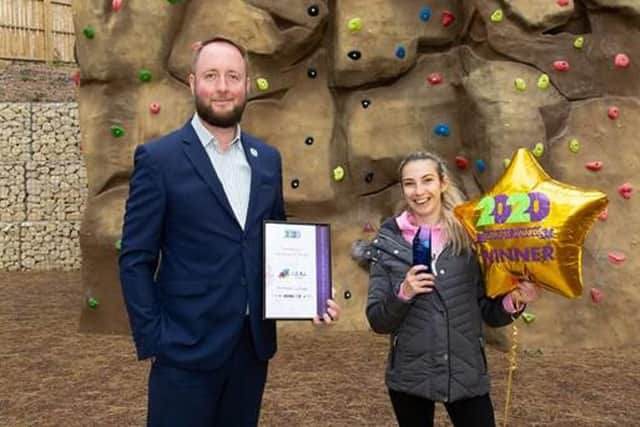 Edward Johnstone, assistant principal for development, with the award for design and innovation, with Lou-Lou De-Ville, a Portland day service citizen.
