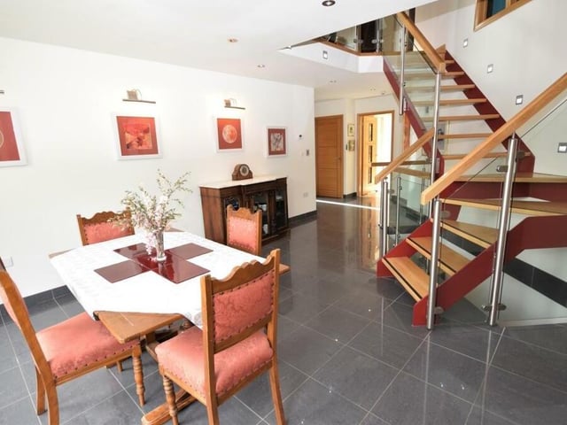 Within the dining room is a dramatic, contemporary feature staircase that leads up to the first floor of the property.