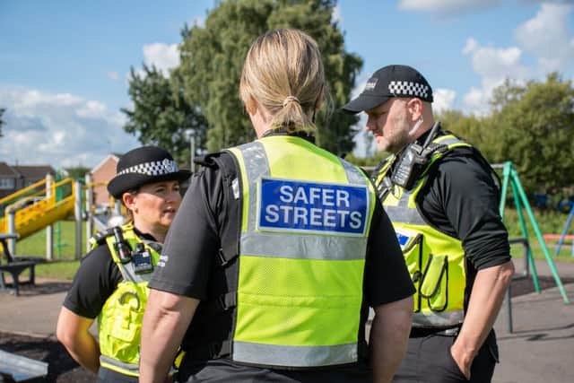 Police and community protection officers in hi-vis jackets