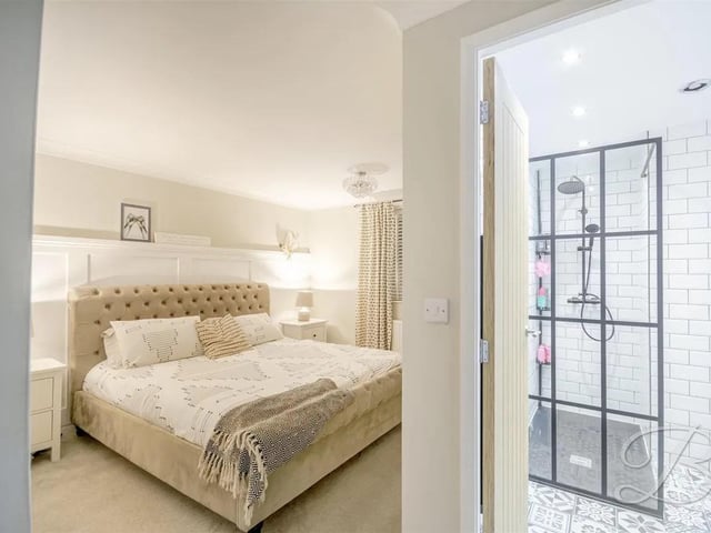 The master bedroom boasts an en-suite bathroom, providing a private sanctuary for relaxation.