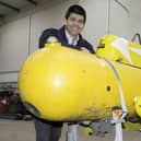 Auctioneer Paul Cooper with the mini submarine