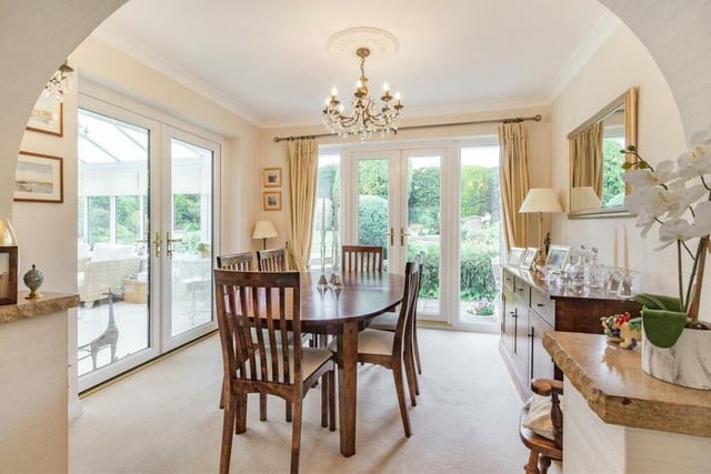 The open-plan lounge flows seamlessly into this bright and inviting dining area, which has two sets of French doors. One leads out to the back garden, while the other leads into the conservatory.