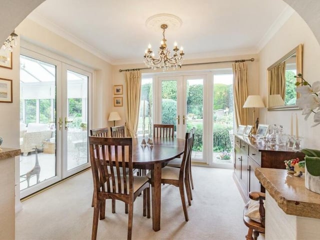 The open-plan lounge flows seamlessly into this bright and inviting dining area, which has two sets of French doors. One leads out to the back garden, while the other leads into the conservatory.