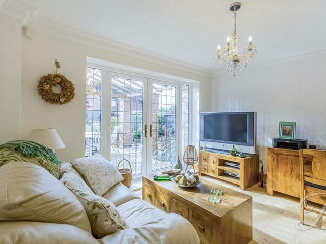 The second reception room is this splendid snug, which also has an oak floor, as well as large patio doors that lead to the rear garden.