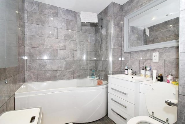 The bathroom at the Stockwell Gate flat is all gloss and sparkle. It's a good size too, with everything you need, from bath and overhead shower to wash hand basin and WC.