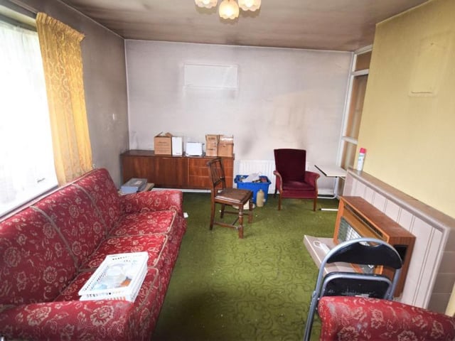 Let's begin our look at the bungalow in this good-sized lounge. The window faces the front of the property, and the room features a wall-mounted gas fire.