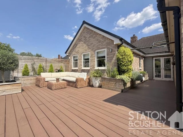 A generous seating area offers an ideal setting for al fresco dining during the warmer months