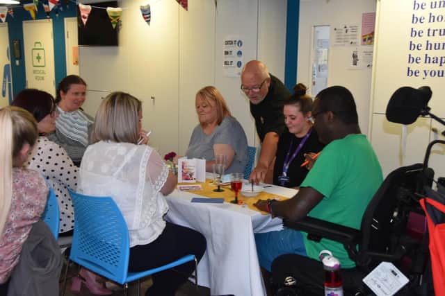 Clients and staff enjoy food and social time.