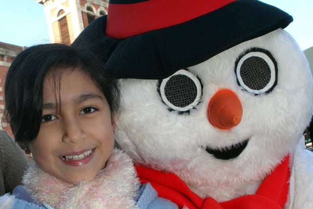 Firdous Mir aged 8 from Chesterfield is pictured with Frosty the Snowman at the Chesterfield Christmas market in 2006