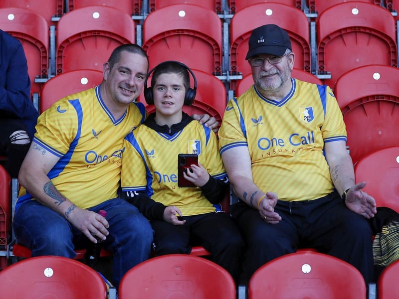 Mansfield Town fans watch the 2-2 draw at Doncaster on 15 August 2023.