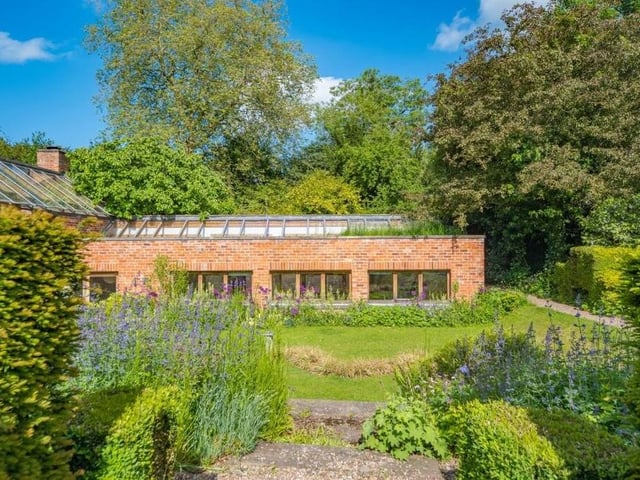 Floor one of the £1.5 million Westhorpe property looks out on to a lawn, trees, plants and bushes.
