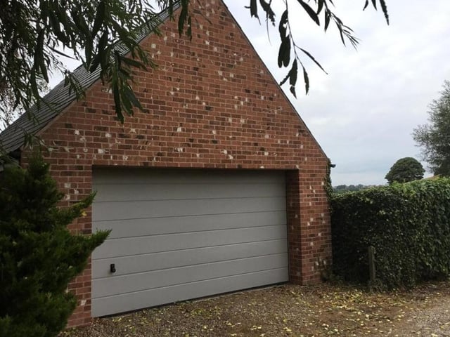As we step outside, off-street parking space at the front of the property is complemented by this sturdy, free-standing double garage