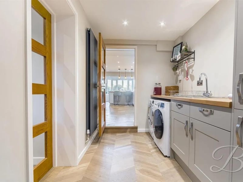 Fitted with wall and base cabinets, ample worktop space and an inset sink and drainer. There is also space and plumbing for a washing machine and tumble dryer.