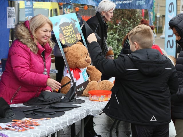 Handing out witch hats in the Market Place. 2023.