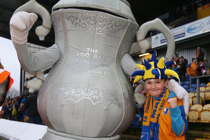 A young fan poses with an inflatable FA Cup before the Mansfield Town v Liverpool tie on January 6, 2013.