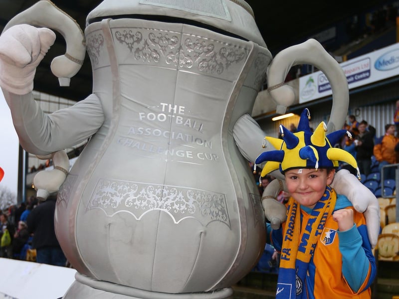 A young fan poses with an inflatable FA Cup before the Mansfield Town v Liverpool tie on January 6, 2013.