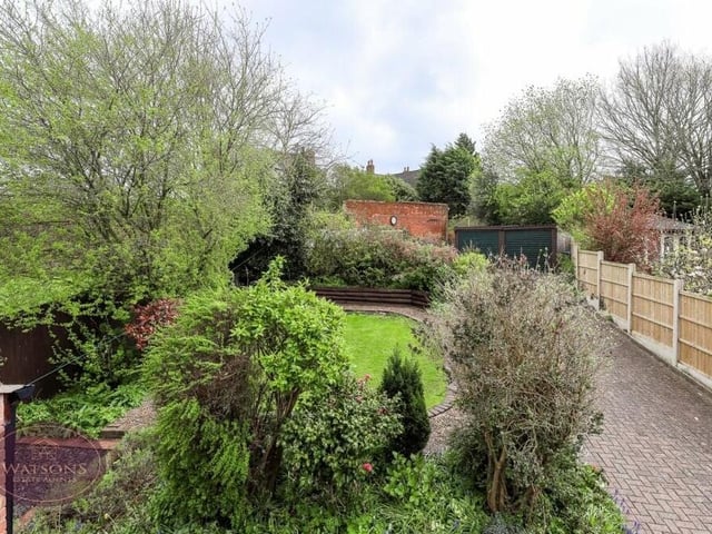 The private rear garden, which features a turfed lawn, raised flowerbeds and a range of mature plants and shrubs, provides perfect seclusion to enjoy countryside views.