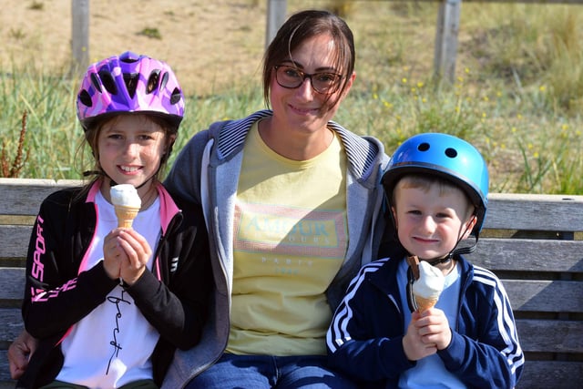 Helen Renno with children Emilia Renno, 11, and Ethan Renno, five, enjoying ice cream in the sun.