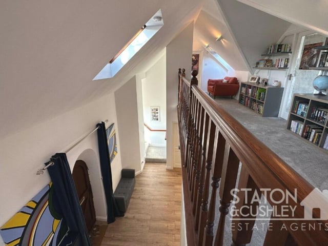This second shot of the gallery landing shows how it overlooks the entrance hall and front door.