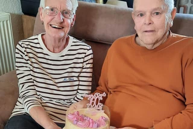 Tom and Margaret with a special anniversary cake at their surprise family party on Sunday.