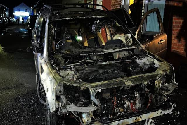 The burnt-out wreck of the vehicle