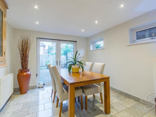 The dining room, which sits next to the kitchen, is a delightful space. It has tiled flooring, underfloor heating, downlights and also French doors that lead outside.