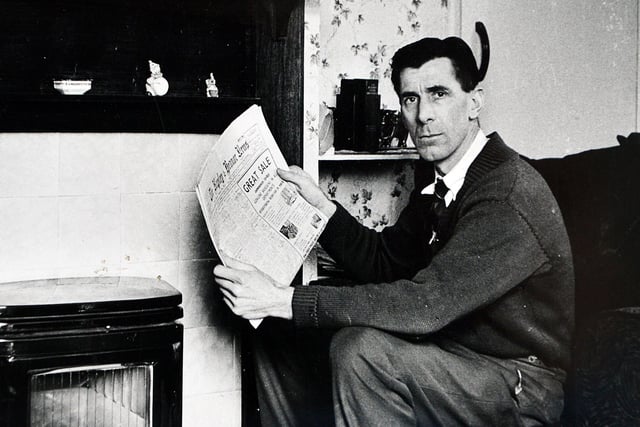 George seen holding a copy of the Ripley and Heanor News.