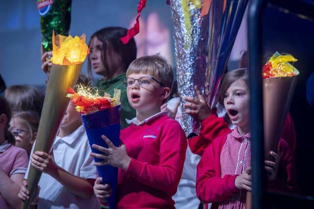 Children carried Olympic torches created at school on to stage at the Motorpoint Arena.