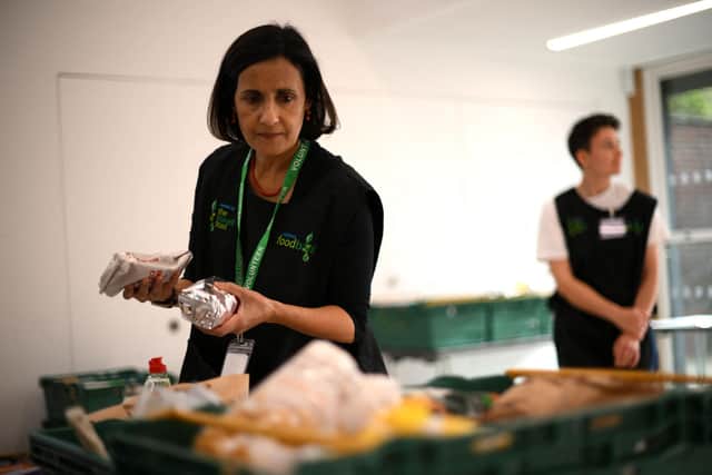 A member of staff sorts through food items inside a food bank.