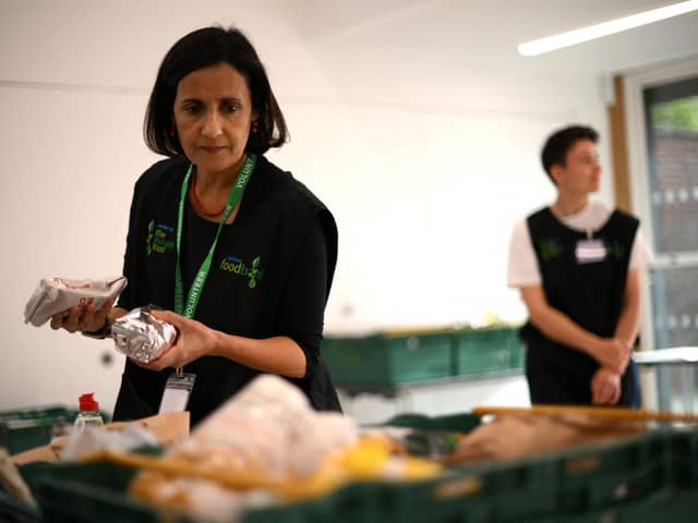 A member of staff sorts through food items inside a food bank.