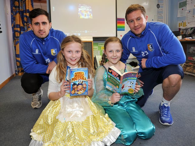 World Book Day at Holly Primary School, Mansfield Town footballers visited the school to listen to the children read, pictured are Chris Clements and Jamie Mcguire in 2014.