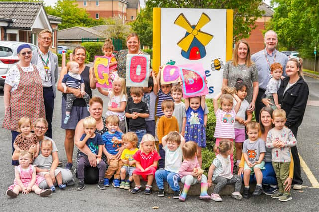 Staff and children celebrate the result.