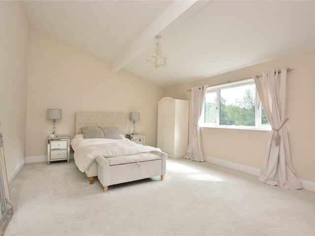 There are four bedrooms throughout the property, including this stylish master room which benefits from its own en-suite.
