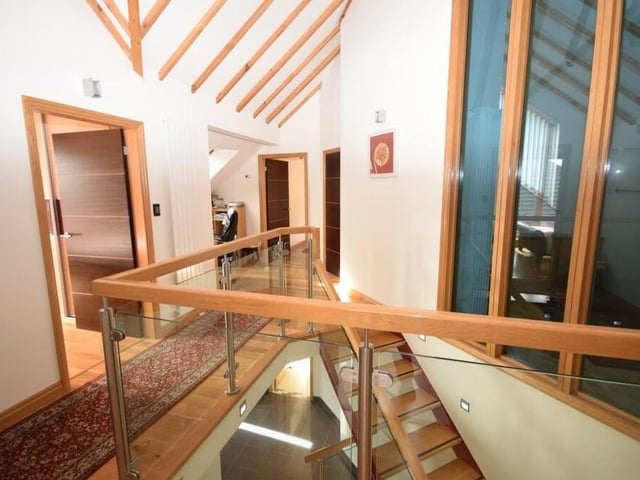 Moving upstairs now, and on to the spectacular galleried landing, with its impressive vaulted ceiling and large windows. The floor is solid oak and there's a useful, versatile area that is currently used as a study space.