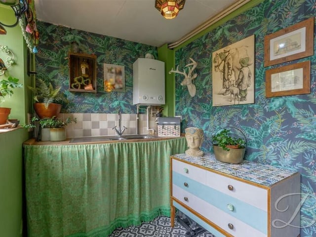 Just off the breakfast kitchen is this handy utility room, with inset sink and door leading outside.