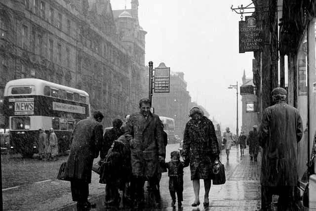 Pedestrians brave the snow storms on North Bridge in February 1964.