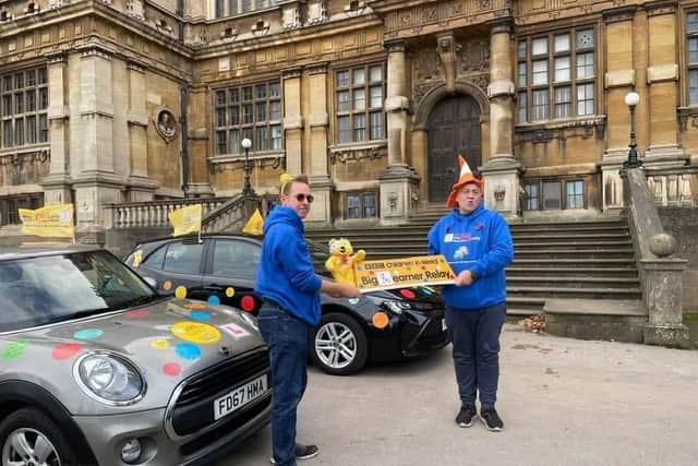 Driving instuctor Tim Elmer (left) receiving the Pudsey top box at Wollaton Hall.