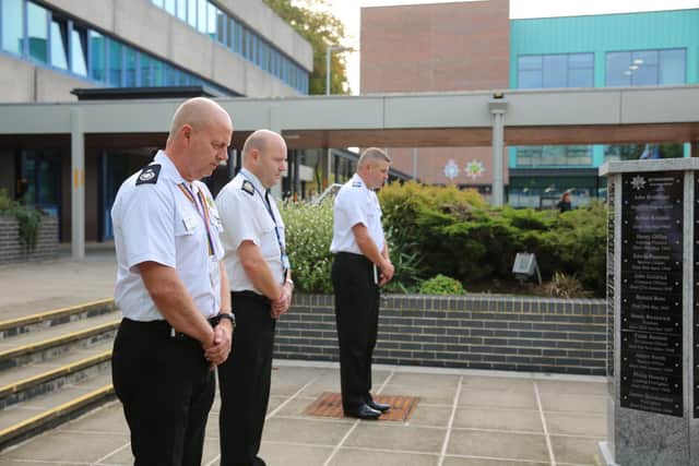 Remembering fallen colleagues are , from left, Assistant Chief Fire Officer Mick Sharman, Chief Constable Craig Guildford and Chief Fire Officer Craig Parkin