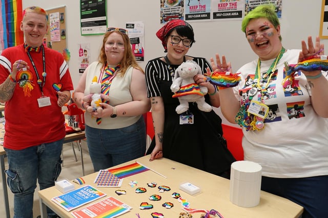 From left, apprentice technician Maddie Esswood and painting and decorating student Tasha Yates admire the Pride-themed merchandise on sale at the construction centre, joined by Ashfield Voluntary Action stallholders Elliot Thorpe and Emit Bee.