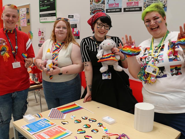 From left, apprentice technician Maddie Esswood and painting and decorating student Tasha Yates admire the Pride-themed merchandise on sale at the construction centre, joined by Ashfield Voluntary Action stallholders Elliot Thorpe and Emit Bee.