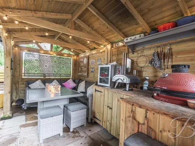 The garden features a second sheltered patio complete with a built-in BBQ—perfect for outdoor dining and entertaining.