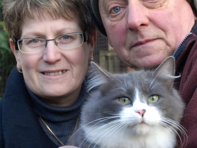 Lesley Stendall left presents £145 to Philip Clarke of Kirkby Cats Home - pictured with Smokey the cat.
