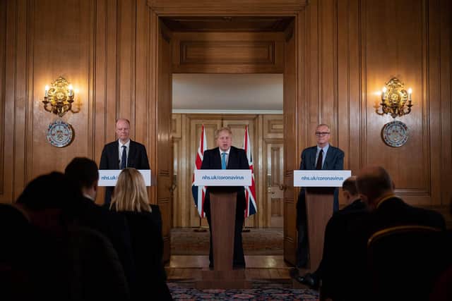 Chief Medical Officer Chris Whitty (L) and Chief Scientific Adviser Patrick Vallance (R) look on as Britain's Prime Minister Boris Johnson addresses a news conference to give a daily update on the government's response to the novel coronavirus COVID-19 outbreak, inside 10 Downing Street in London on March 19, 2020. (Photo by Leon Neal / POOL / AFP) (Photo by LEON NEAL/POOL/AFP via Getty Images)